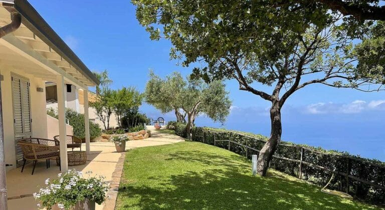 Villa Splendida rear terrace with outdoor dining area and Mediterranean coastline views