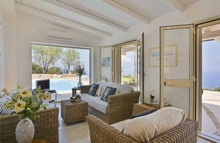 Villa Splendida living room with panoramic picture window overlooking pool and sea