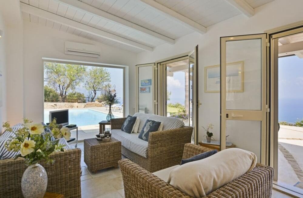 Villa Splendida living room with panoramic picture window overlooking pool and sea