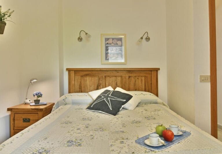 Villa Splendida third bedroom overlooking terraced gardens and outdoor dining area