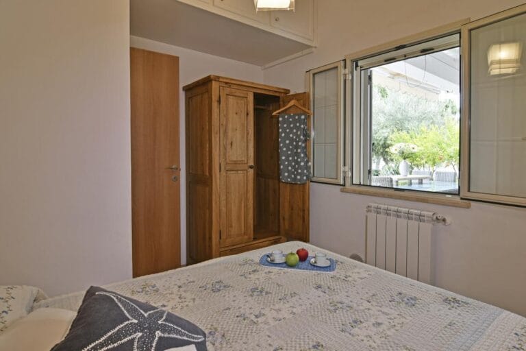 Villa Splendida third bedroom overlooking terraced gardens and outdoor dining area