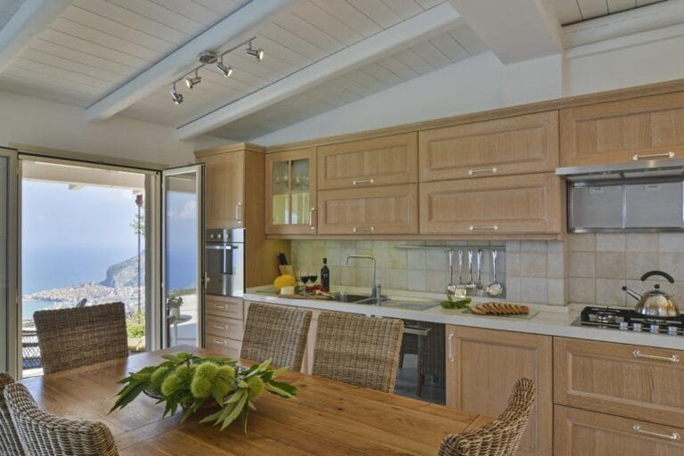 Villa Splendida modern kitchen with floor-to-ceiling windows and Mediterranean views