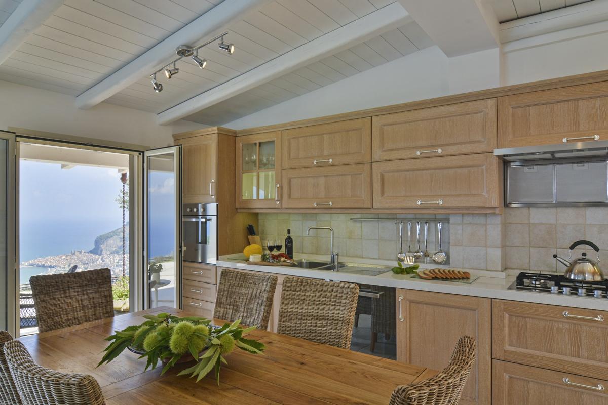 Villa Splendida modern kitchen with floor-to-ceiling windows and Mediterranean views